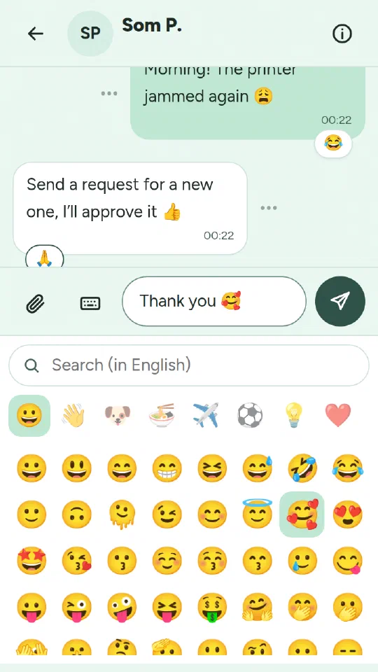 The emoji panel open where the phone's keyboard was, with Thank you and a smiling face with hearts typed in the message box